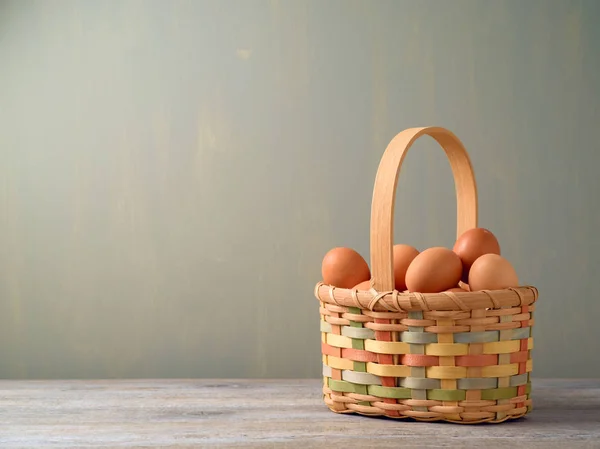 Fresh eggs in wicked basket — Stock Photo, Image