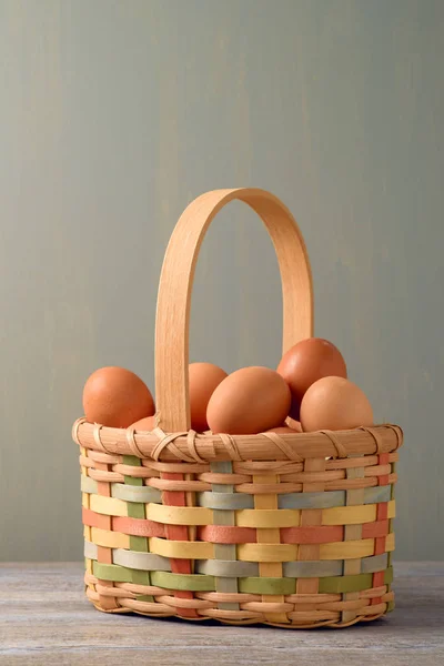 Fresh eggs in wicked basket — Stock Photo, Image