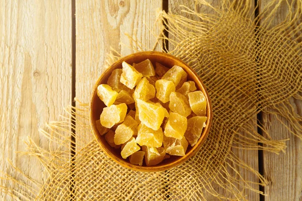 Food and healthy eating concept. Dried ginger with sugar on wood — Stock Photo, Image