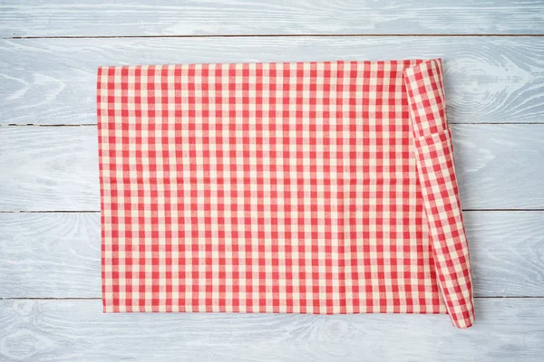 Red checked tablecloth on rustic wooden table. Kitchen, cooking — Stockfoto