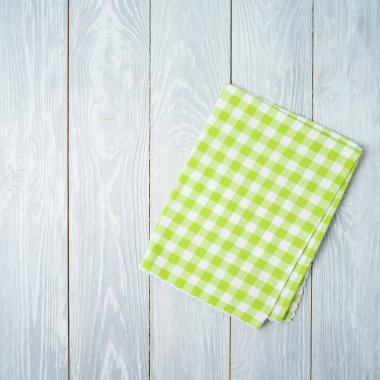 Green checked tablecloth on rustic wooden table. Kitchen, cookin