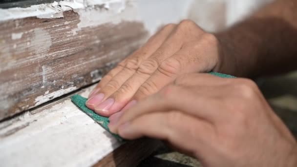 Close up slow motion shot of a man using two hands to sand a very worn window frame — Stock Footage Close Slow Motion Shot Man Using Two Hands Sand Very Video Clip