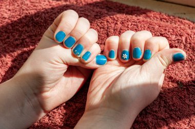 Vibrantly painted blue fingernails clipart