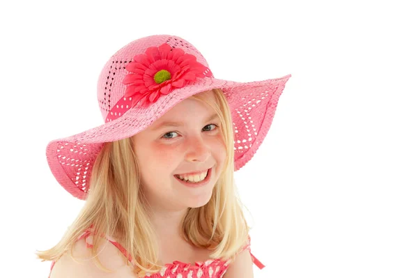 Beautiful young blonde girl with a big smile and wearing a big pink floppy hat. Isolated on white studio background — Stock Photo, Image