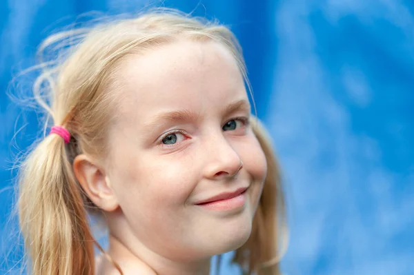 Close up headshot of pretty young girl with pigtails making eye contact — Stock Photo, Image