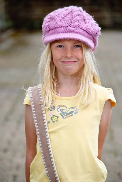 Pretty young blonde hippie girl in pink hat — Stock Photo, Image
