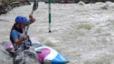 BRATISLAVA, SLOVAKIA - CIRCA  AUGUST, 2017: Slalom Kayak paddler crossing a V-Wave and practising up stream gates in a K1 kayak