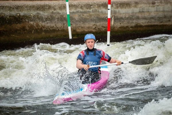 GB Canoe Slalom Athlete crossing white water after negotiating an upstream gate on a wave. Women\'s C1W class