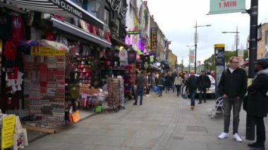 30 Eylül 2019 'da Camden High Caddesi' ndeki renkli dükkanlardan geçen yavaş ZOM In: Arka plandaki ünlü Camden Lock Köprüsü tabelası.