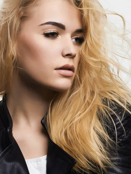 Beautiful blond girl in leather coat — Stock Photo, Image