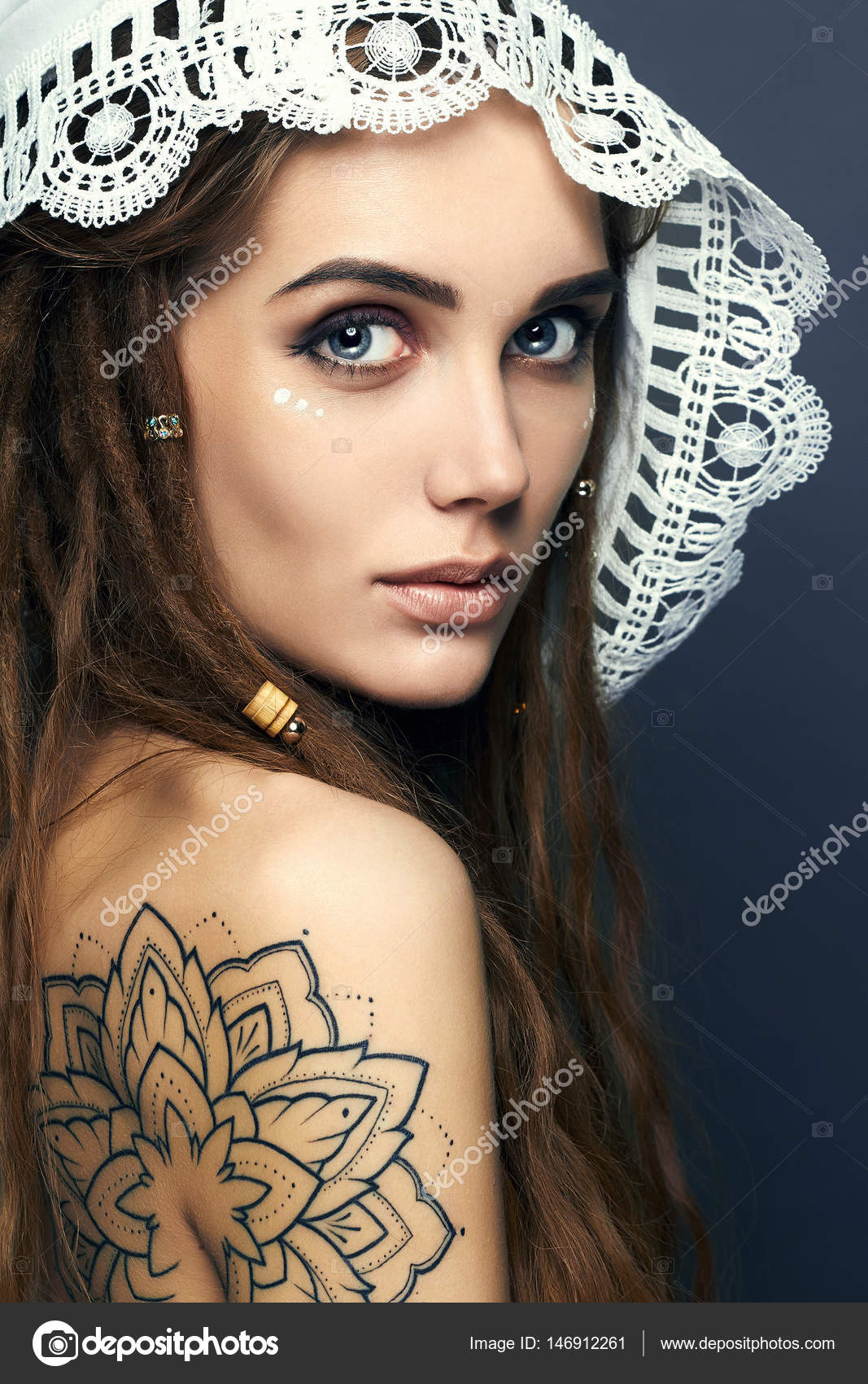 Beautiful Girl with tattoo,dreadlocks and lace shawl Stock Photo by  ©EugenePartyzan 146912261