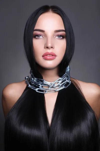 Beautiful woman with long healthy hair in chain — Stock Photo, Image