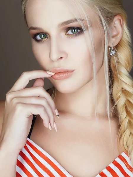 beautiful woman with braided hair, make up and manicure