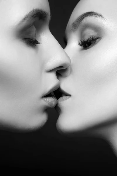 sensual kiss of couple beautiful young women