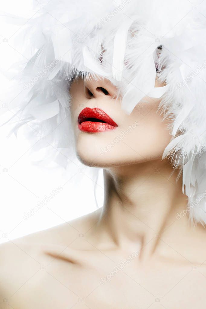 Beautiful Girl in white feathers Hat. Make-up