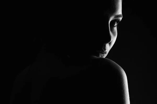 Beautiful Woman silhouette in the dark. Black Photo Girl. Black and white art portrait