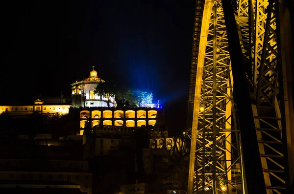 Portugal, night Porto, lights of night city, night panoramic view of The Eiffel Bridge, Ponte Dom Luis,  Bridge Ponti Di Don Luis, gold lights of Porto, lantern illuminates the night blue sky