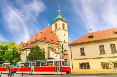 Catholic Church of St Henry and St Kunhuta (Kostel sv. Jindricha a sv. Kunhuty) and Typical old retro vintage tram on tracks in New Town Prague historical city centre, Bohemia, Czech Republic