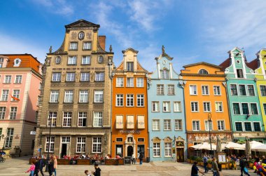 Gdansk, Polonya, 15 Nisan 2018: Dluga Long Market caddesindeki Dlugi targ meydanındaki mavi gökyüzü arka planına sahip güzel, tipik renkli binaların cephesi