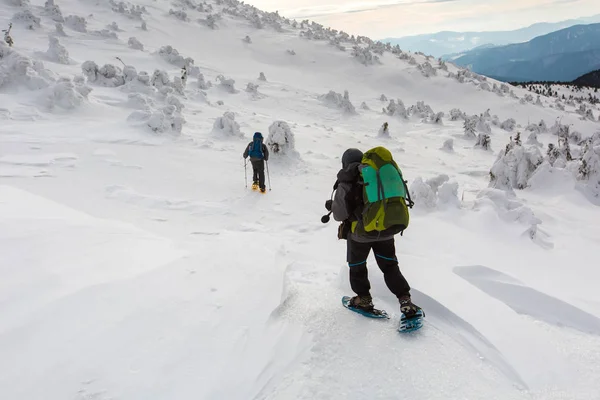 Man vandra i vinter berg innan åskväder — Stockfoto