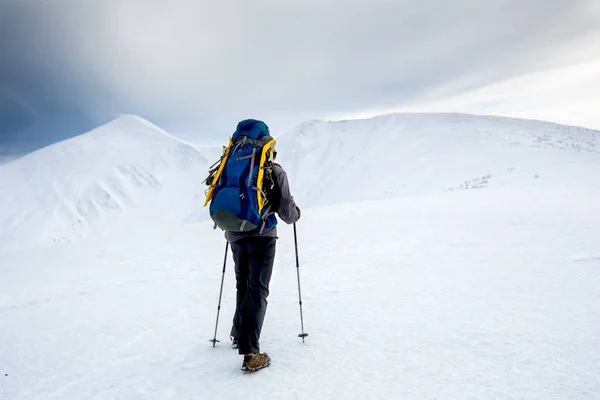 Hombre de senderismo en las montañas de invierno antes de tormenta —  Fotos de Stock