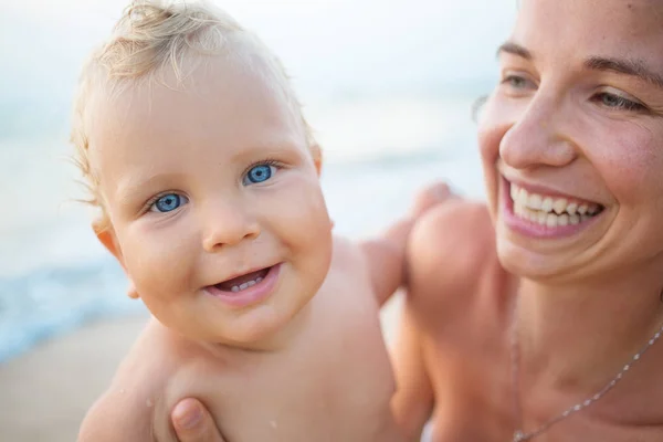 A mother and her baby are smiling at camera Stock Photo