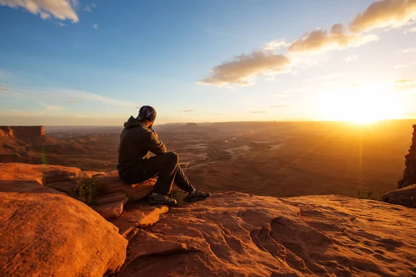 Hiker meets sunset at Grand view  point in Canyonlands National