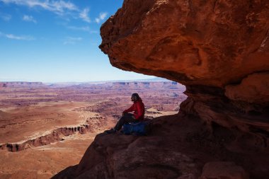 Hiker rests in Canyonlands National park in Utah, USA clipart