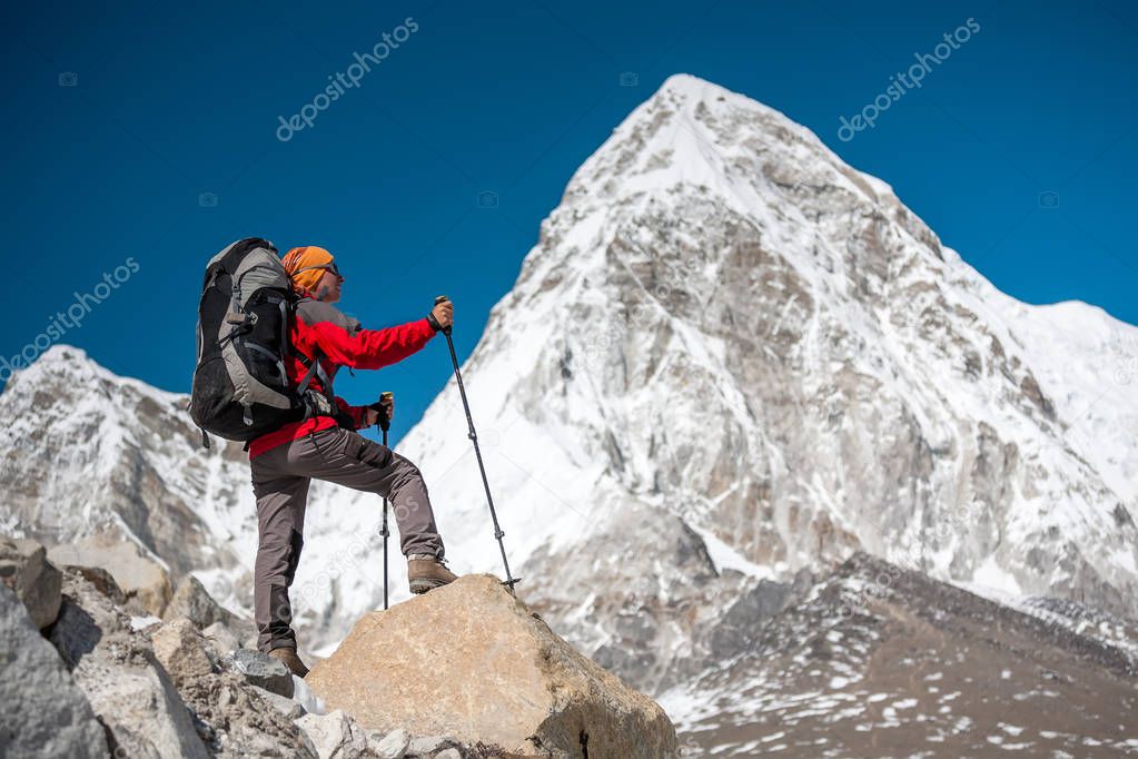 Trekker approaching PumoRi mountain in Khumbu valley on a way to