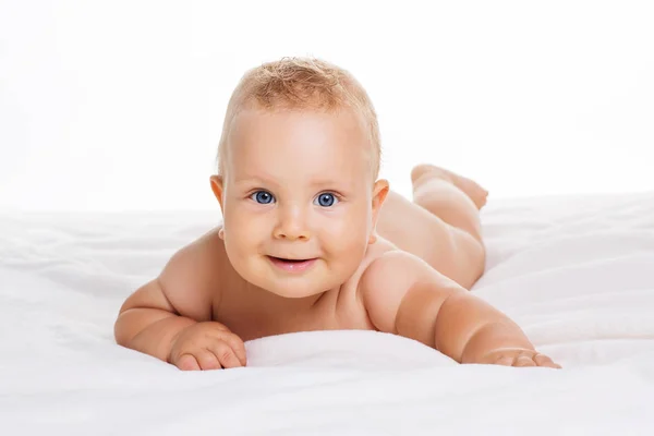 可爱微笑的婴儿躺在毛巾上白色孤立 — 图库照片