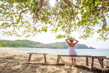 Kadın geri kalan deniz sahilinde alır.