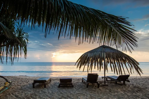 Sun loungers with umbrella on the beach, sunrise — Stock Photo, Image