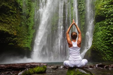 kadın meditasyon yoga şelaleler arasında yaparken
