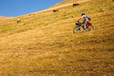 Dağ bisikletçinin Tusheti bölgesi dağlarında seyahat ediyor,