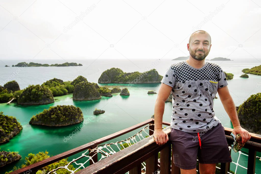 Caucasian man standing at the viewpoint of Piaynemo island, Raja