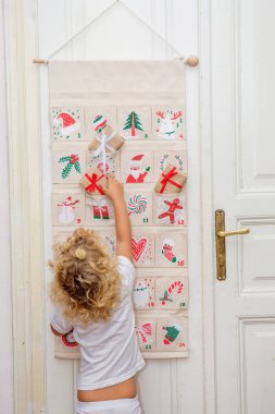 Çocuk geliş takviminden bir hediye açar