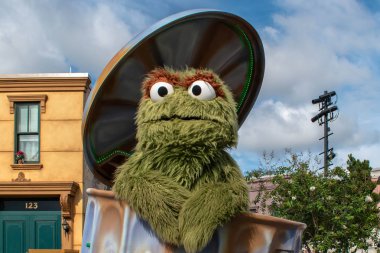 Orlando, Florida. November 06, 2019. Oscar the Grouch in Sesame Street Party Parade at Seaworld 1 clipart