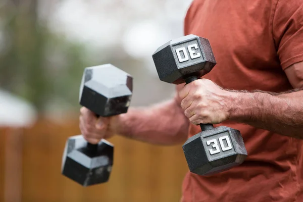 Adult male exercising with free weights