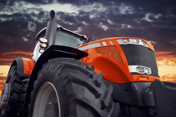 Zemědělský traktor pracuje při západu slunce — Stock fotografie