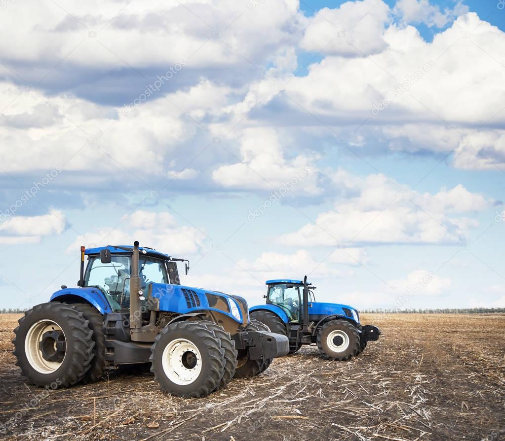 Two tractors work in the field