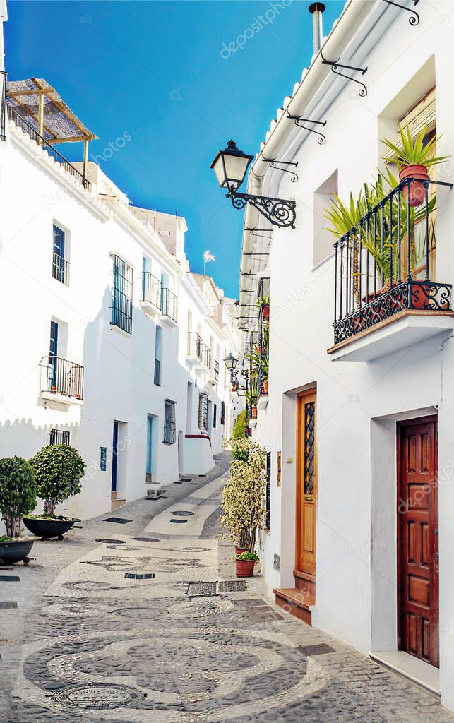 Street of white walls in a village of Andalusia called Frigiliana