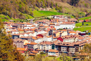 Cangas de Onis village in Asturias in the north of Spain in a sunny day clipart