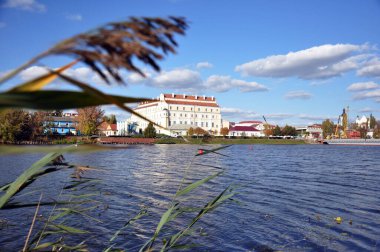 Views of the city of Pinsk, Republic of Belarus. The Jesuit College from the Pina River, overgrown with reeds. clipart