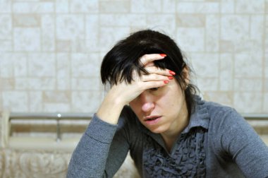Genç bir kadın alnına eliyle dokunarak şiddetli bir baş ağrısı hisseder. Ani bir panik atak ya da evde anksiyete yaşıyor. Odaklanamıyorum, odaklanamıyorum.