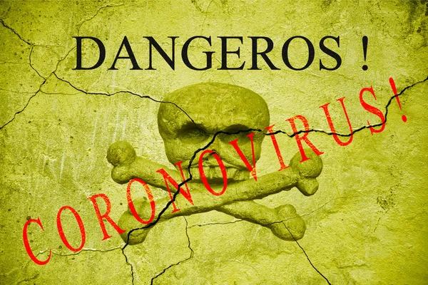 The word dangerous on an old cracked wall with a bas-relief of a skull and crossbones. Coronavirus — Stock Photo, Image