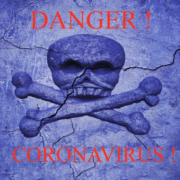 The word danger on an old cracked wall with a bas-relief of a skull and crossbones. Coronavirus infection 2019 - nCoV — Stock Photo, Image