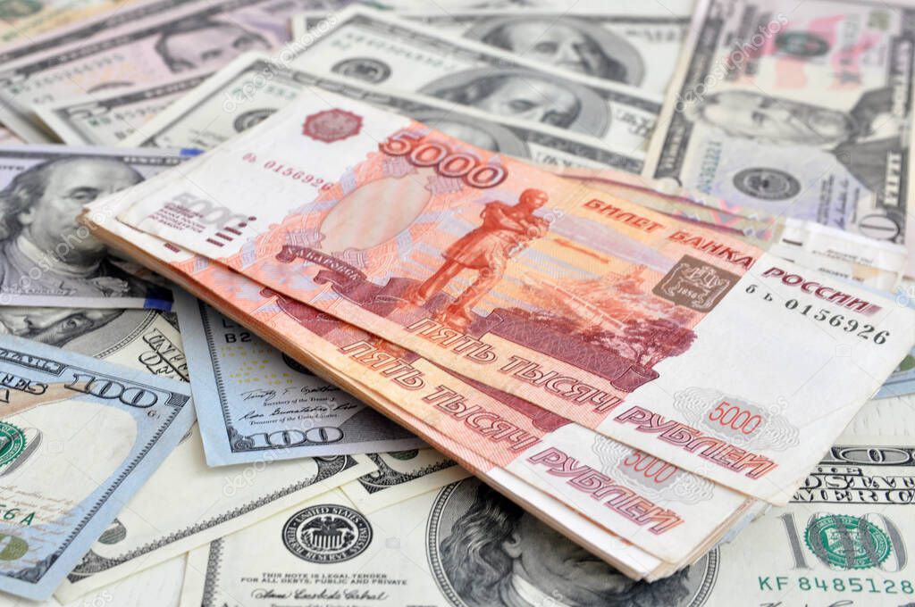 Russian 5000 rubles and 100 dollars close-up, the concept is laid out as a background. The crisis. Out of focus, blur