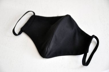 Esnek bantlı siyah kumaştan yapılmış yeniden kullanılabilir solunum maskesi. Beyaz arka plan görünümlü yüz maskeleri. Coronavirus Koruma, COVID-19.