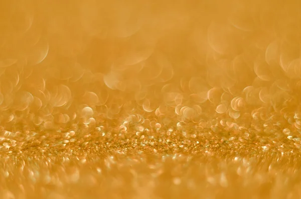 Abstrato Christmast fundo dourado bokeh com brilhantes brilhos defocus. Brilhantes borrados cintilante poeira macro close-up, espaço de cópia para o logotipo do texto — Fotografia de Stock