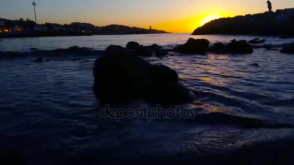 Mulher olhando para o nascer do sol na costa do mar - 4K — Vídeo de Stock